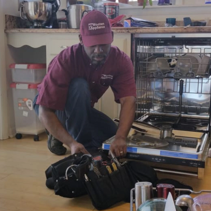 technician repairing a dishwasher in a house halethorpe md